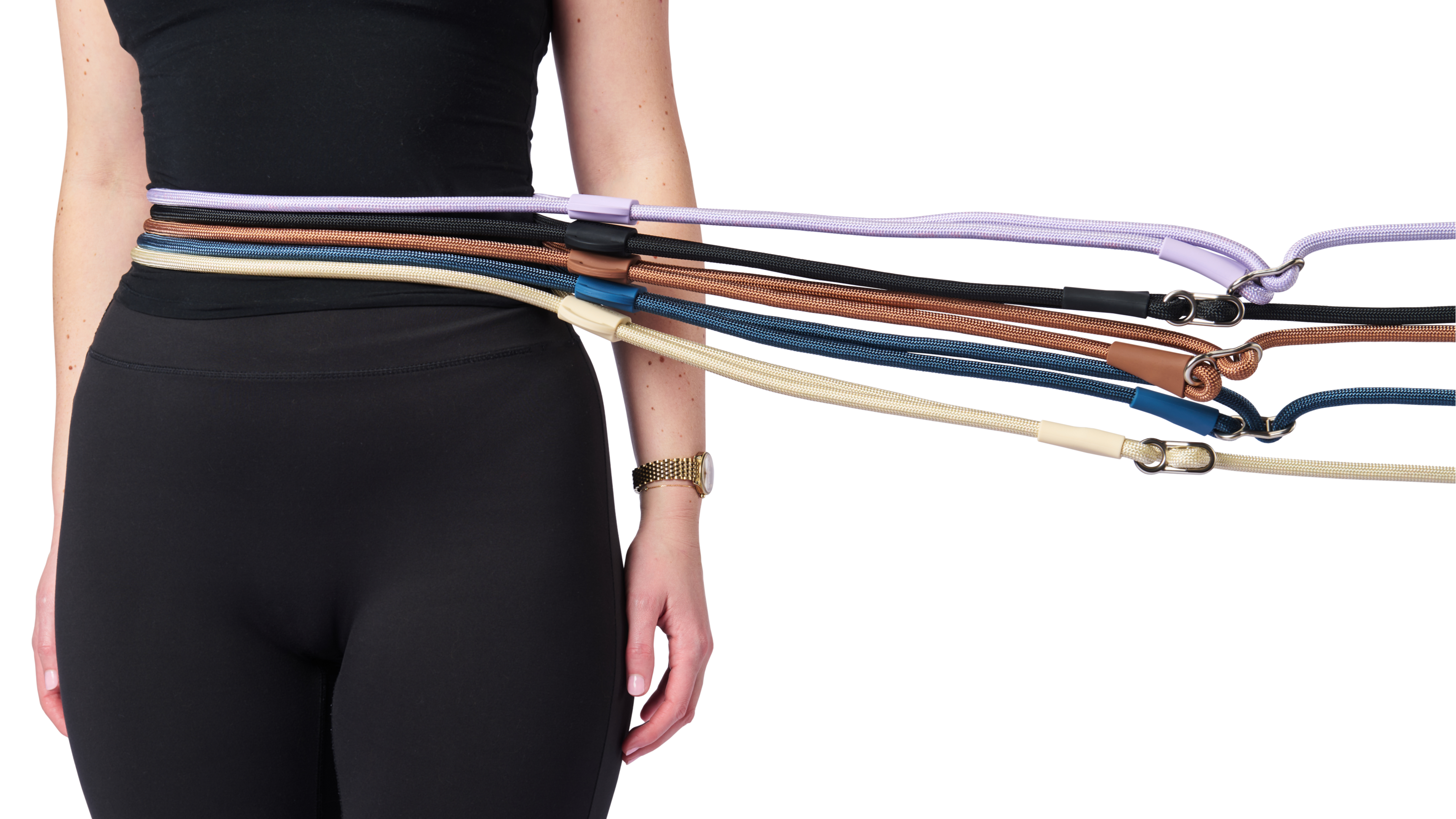 Person wearing a black outfit with multiple colorful belts draped over them on a white background